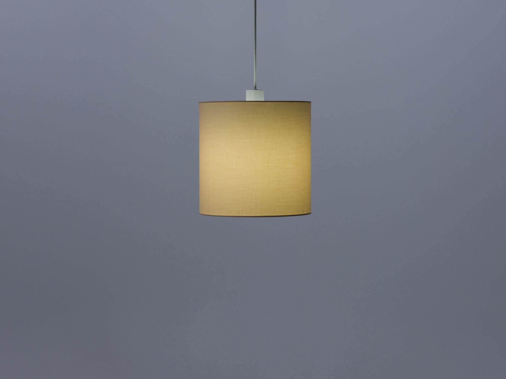 Beige pendant shade with light on side view